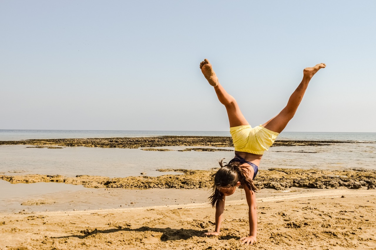 a woman doing a handstand showcasing how Functional Medicine can help improve energy.