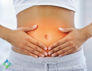 a person holding their stomach illustrating the inflammation caused by leaky gut.