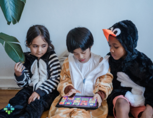 kids sitting around looking down at an ipad displaying a perfect example of tech neck