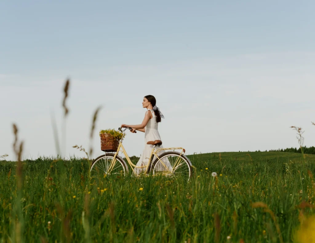 woman cycling through field