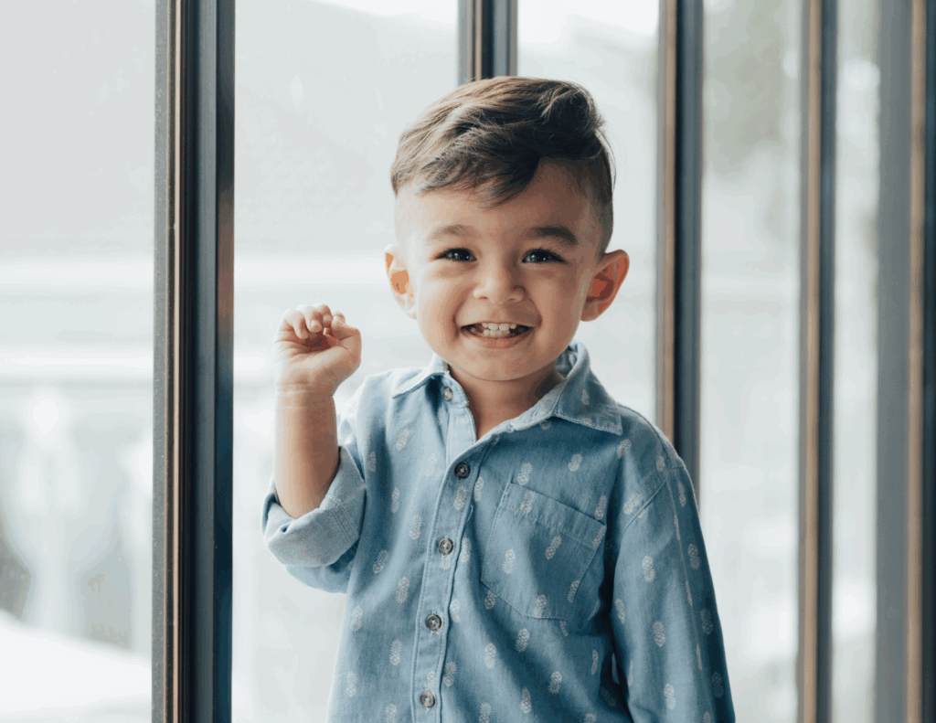 kid standing in front of big windows ADHD and focus issues in children can be helped through Functional Medicine