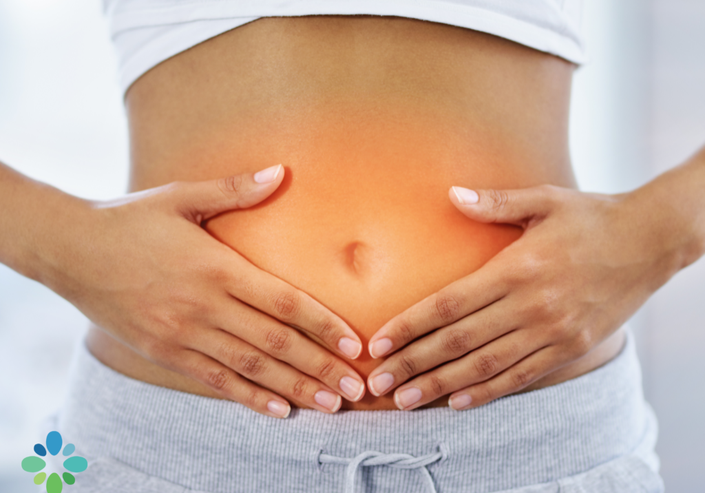 a person holding their stomach illustrating the inflammation caused by leaky gut.
